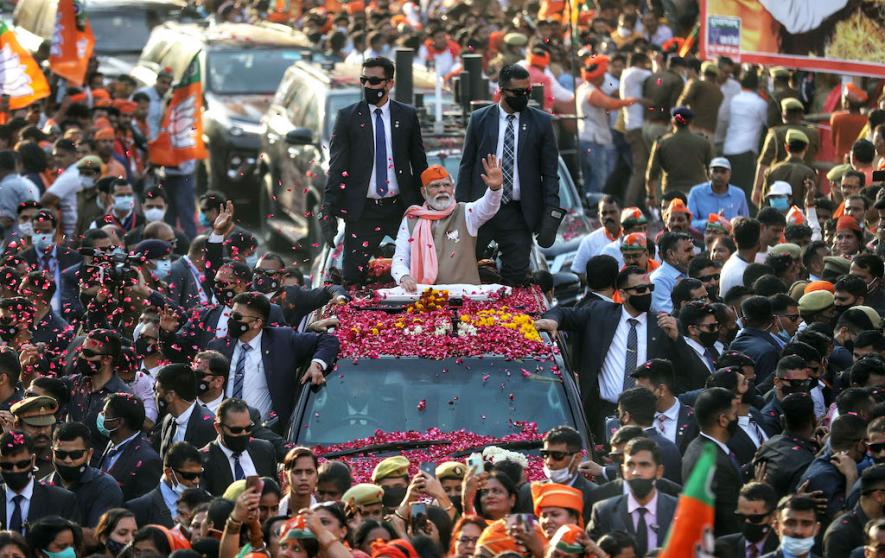 Varanasi, Mar 04 (ANI): Prime Minister Narendra Modi waves to the BJP supporters during a roadshow in support of party candidate for the seventh and last phase of Uttar Pradesh Assembly elections, in Varanasi on Friday.