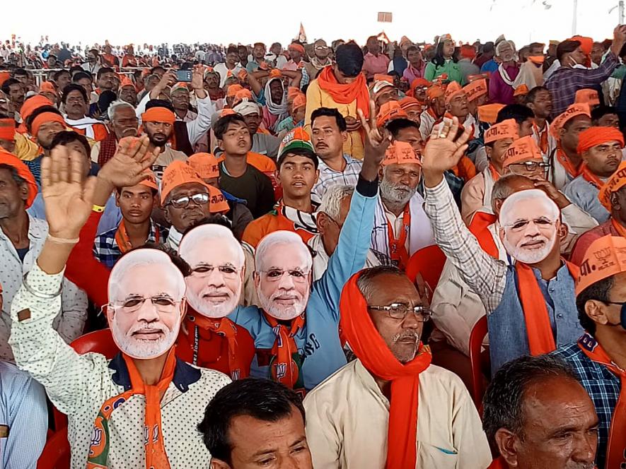 Varanasi, Mar 05 (ANI): Bharatiya Janata Party (BJP) supporters wearing cutouts of Prime Minister Narendra Modi attend a public rally by PM Narendra Modi for the seventh and last phase of Uttar Pradesh Assembly elections, at Khajuri Village, Rajatalab, in Varanasi on Saturday.