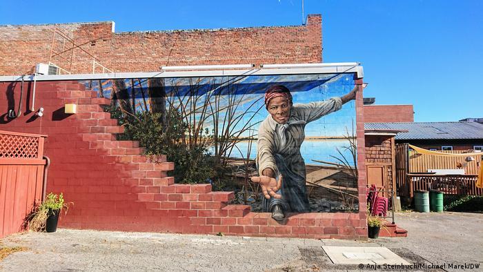 The mural 'Take my hand' by Michael Rosato shows a young Harriet Tubman reaching out to the viewer