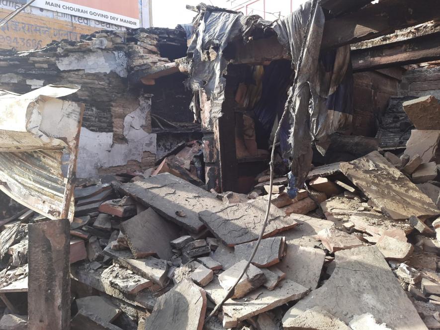 A vandalized and burnt shop at Hatwada bazaar.