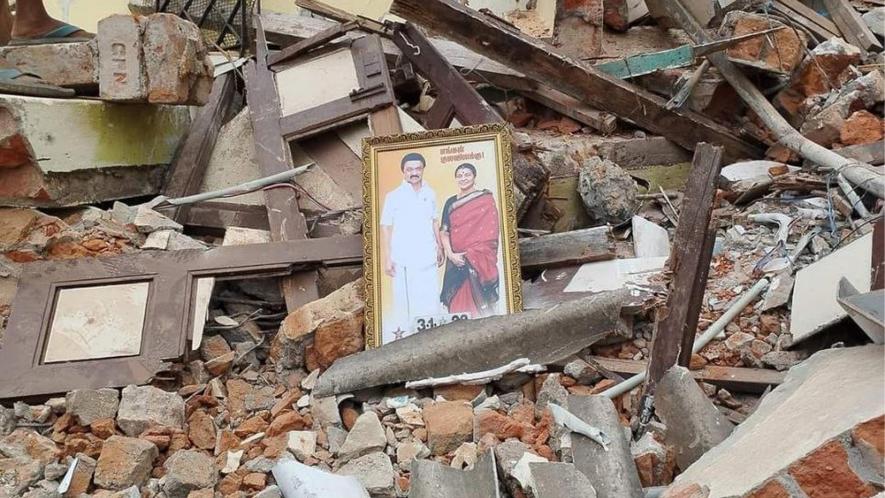 A framed photo of Mr Stalin and his wife lying at a demolished house in the eviction site
