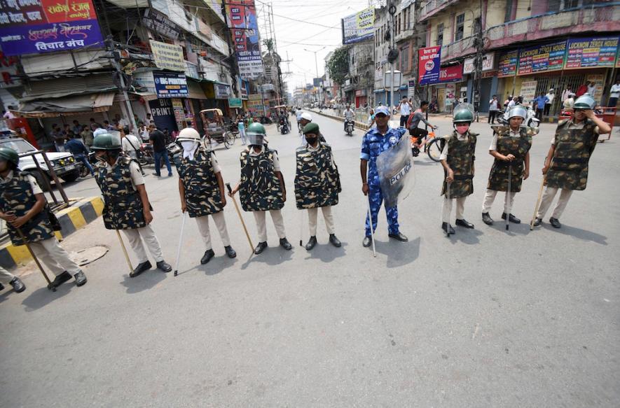 Patna, June 18 (ANI): Rapid Action Force (RAF) and police personnel stand guard during Bihar Bandh that is called to protest against the Agnipath Recruitment Scheme for the Armed Forces, in Patna on Saturday.