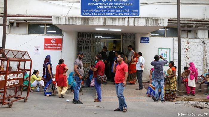 Patients and family members wait in the heat outside the department of obstetrics and gynecology at Safdarjung Hospital