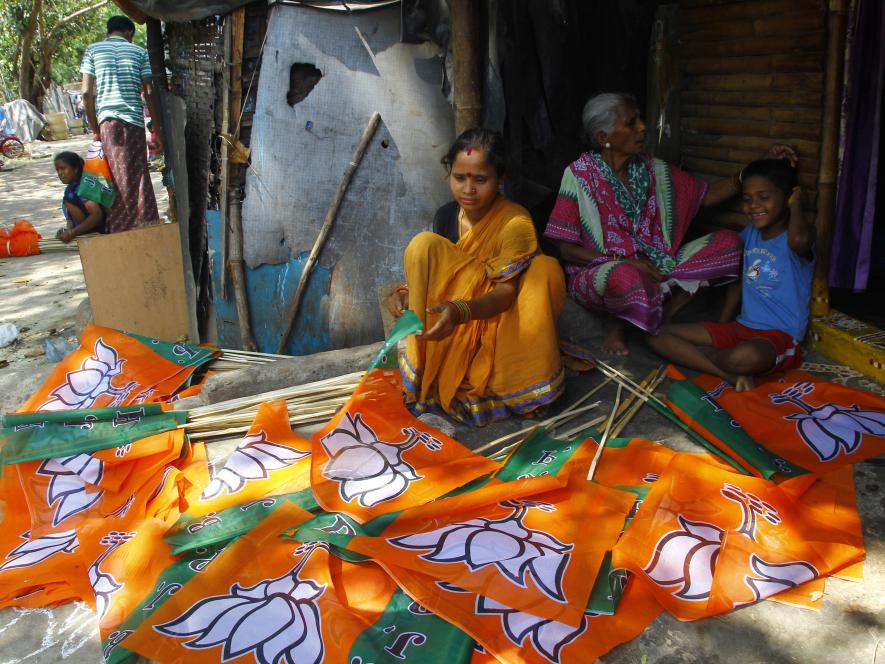 Workers preparing BJP symbol on flag sticks