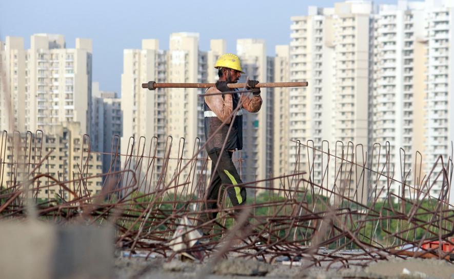 Labourers work at the Dwarka Expressway construction site