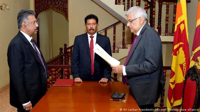 Ranil Wickremesinghe (left) was sworn in as Sri Lanka's interim president after Rajapaksa resigned amid mass protests