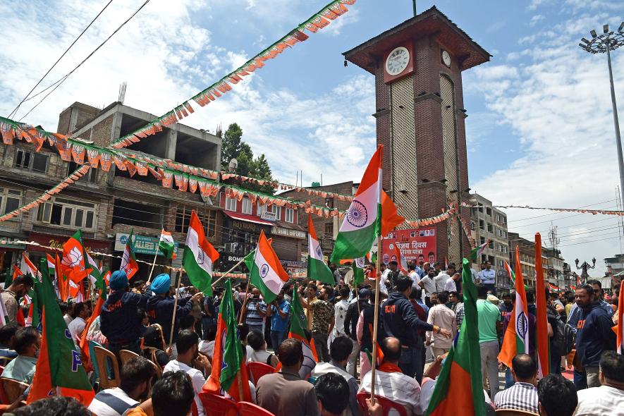 Bharatiya Janata Party (BJP) supporters hold party flags and National flags during the first-ever Tiranga Bike rally flagged off by BJP National General Secretary Tarun Chugh from Ghanta Ghar, Lal Chowk