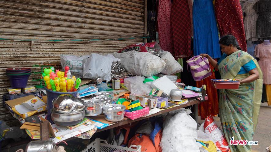 Street vendor Vijayalakshmi arranging her shop on MG Road.
