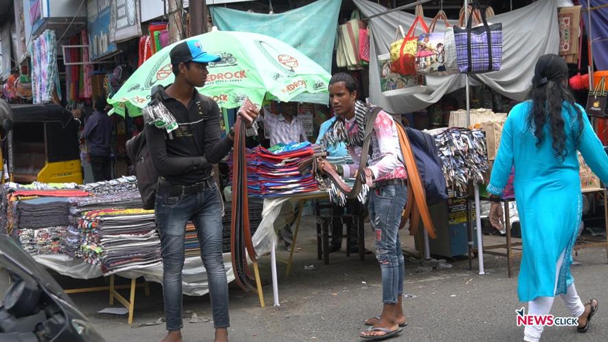 Two youngsters sell belts on MG Road, Puducherry.