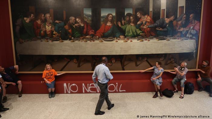 Activists glue their hands to the frame of a copy of Leonardo da Vinci's "The Last Supper" at London's Royal Academy