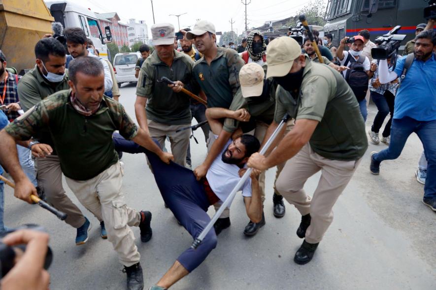 A mourner being detained by personnel of J and K police near Jehangir chowk in Srinagar
