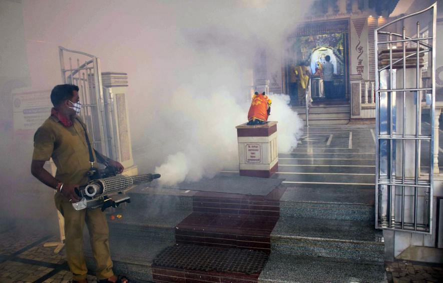 rihanmumbai Municipal Corporation (BMC) Worker sanitizes a premise of a temple as the cases of dengue and malaria rises, in Mumbai