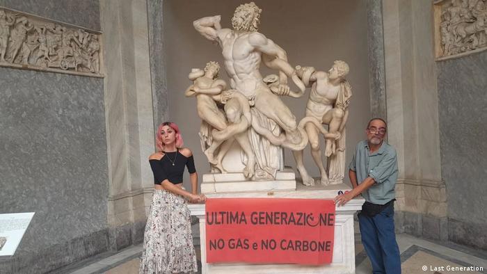 'Last Generation: No gas, No Coal' reads a banner held by climate activists who glued their hands to a statue at the Vatican Museums on August 18