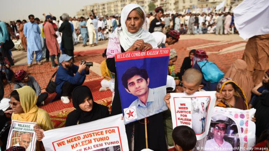 Family members of missing Pakistanis people hold their relatives' pictures at a protest rally of Pashtun Tahafuz Movement (PTM) in Karachi