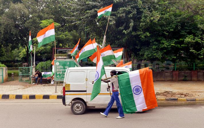 A street vendor sell tricolor flag at traffic red light on the eve of independence day in New Delhi 