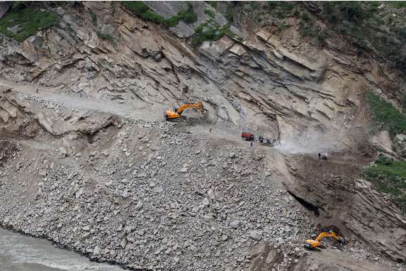Excavators dig tunnels through a mountain in Drabshalla village as part of the construction of the 850 MW Ratle Hydroelectric Project.