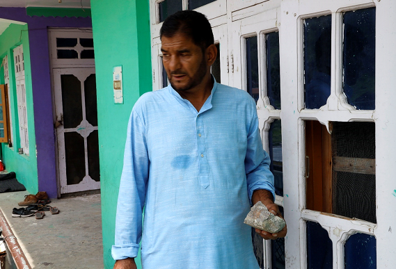 Mohammad Shafi Bhat, a resident of Kishtwar’s Drabshalla village, shows the stone that smashed the window of his house when the employees of the under-construction Ratle Hydroelectric Project blasted a portion of a mountain on July 29.