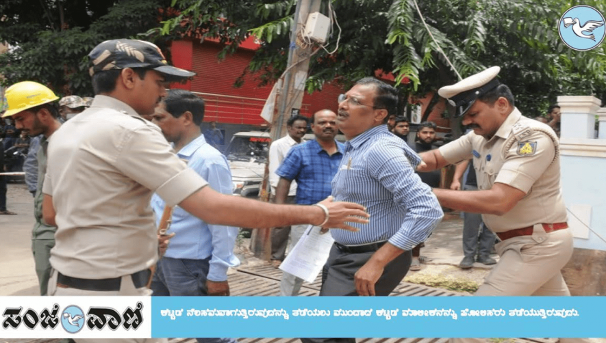 A distraught Govardhan Rao physically held back by police (pic courtesy - Sanjevani News)