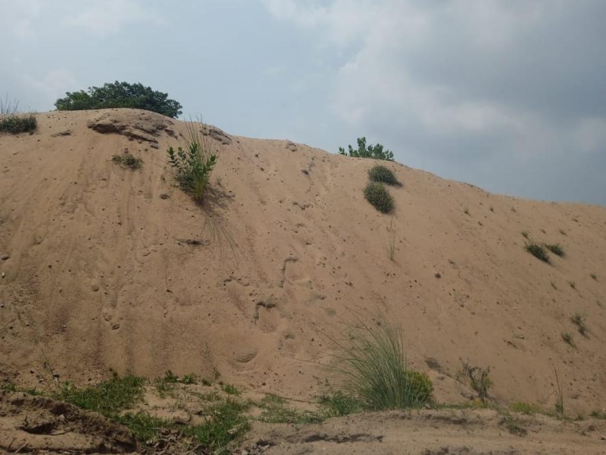 At several places not far away from riverbanks, huge sand dunes illegally mined are visible. The sand is later loaded into heavy vehicles at night. 