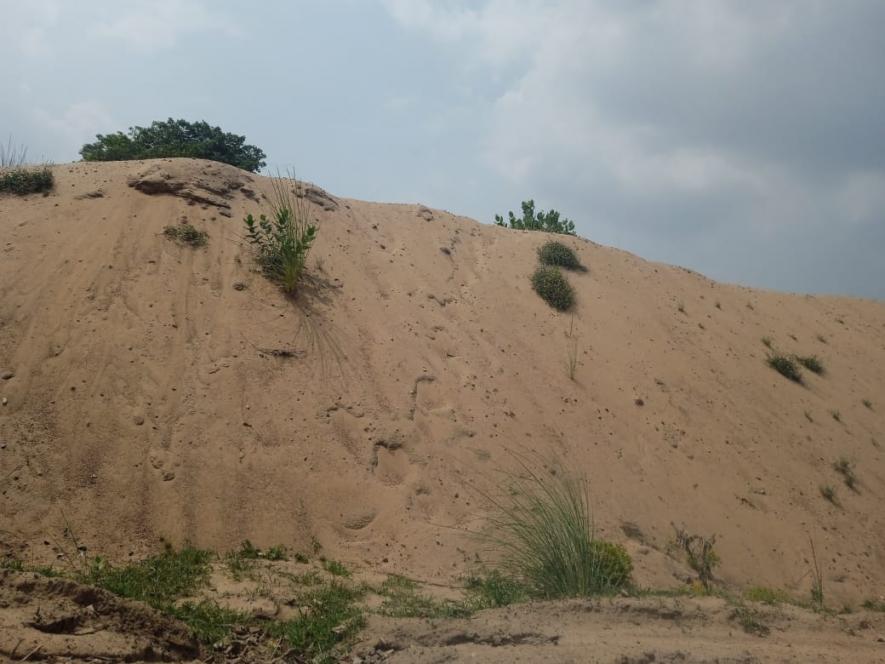 At several places not far away from riverbanks, huge sand dunes illegally mined are visible. The sand is later loaded into heavy vehicles at night.