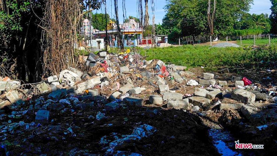 The demolished wall with the Draupathi Amman temple in the background.