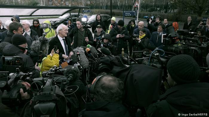 Shipton surrounded by the press