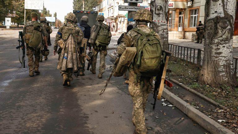 Ukrainian soldiers walk nonchalantly in Bakhmut city, a strategic hub, amidst Russia’s attacks, Donetsk, Oct. 2, 2022
