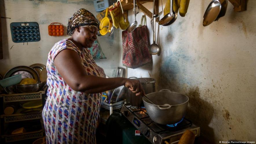 Cameroon's government wants more people to cook with LPG, like this woman here, but needs to assure supply