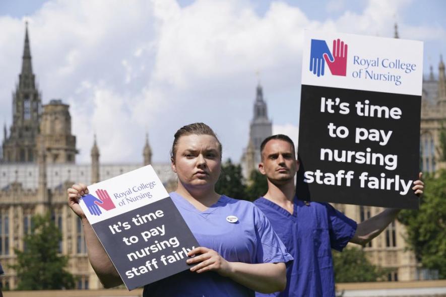 Nurses hold placards outside the Royal College of Nursing (RCN) in Victoria Tower Gardens, London, Wednesday July 21, 2021. 