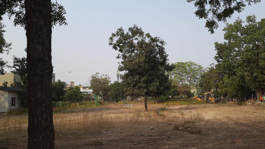 The barren land which once used to be a 4-storey school, now the only visible things are a slide and a JCB