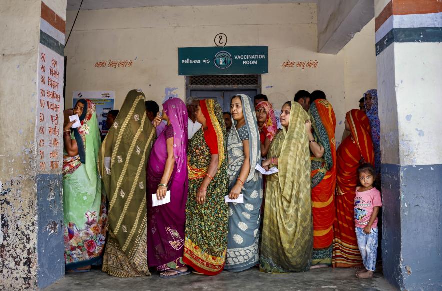  Women wait in a queue to cast their votes at a polling booth during the second and final phase of Gujarat Assembly elections, in Ahmedabad, Monday, Dec. 5, 2022.|