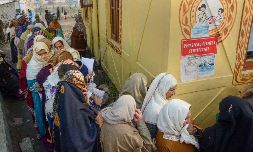 Srinagar: Women wait in a queue to register themselves for a government pension scheme, on a cold winter day, in Srinagar, Monday, Dec. 19, 2022.