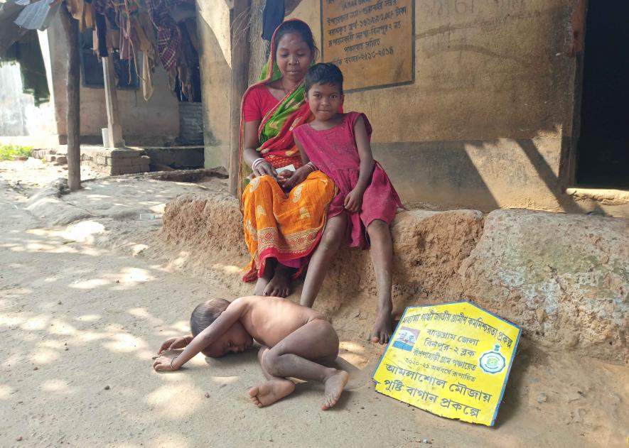 Puchhi Sabar with her mother and malnourished younger brother Kaliya.