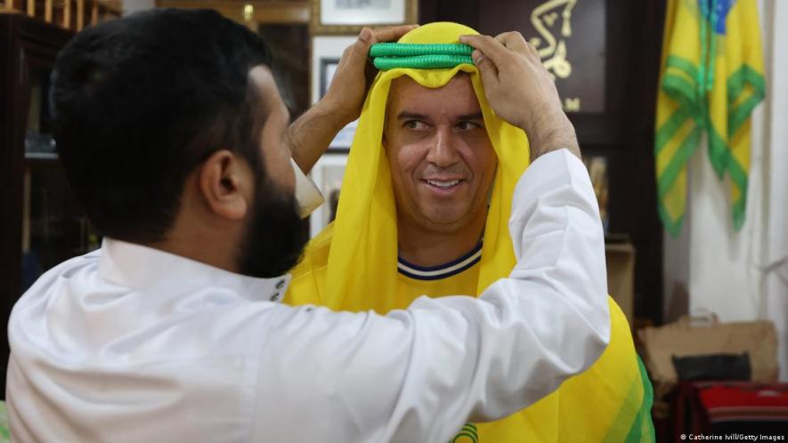 Stand still: Many foreign visitors in Qatar have needed help adjusting their ghutras, including this Brazil fan