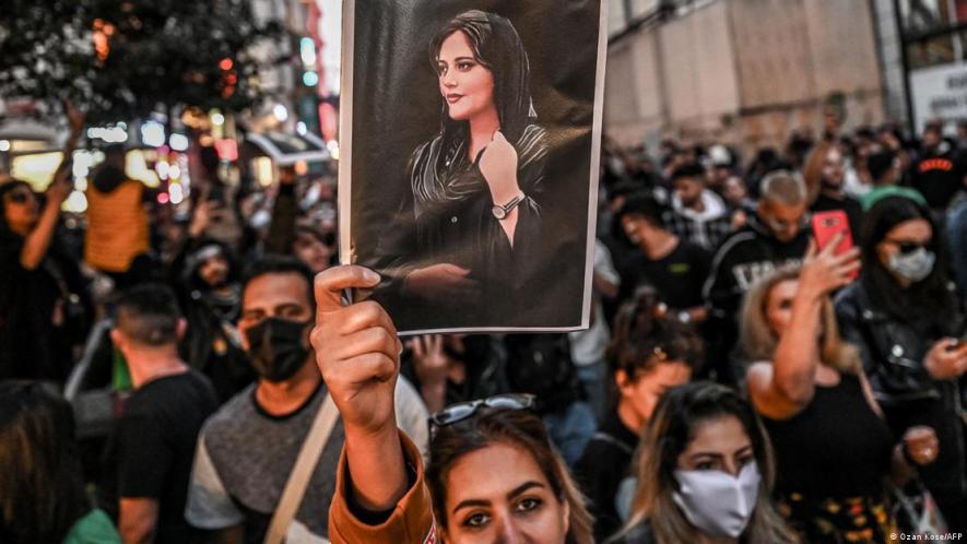 A protester holds a portrait of Mahsa Amini during a demonstration in Turkey in September following her death