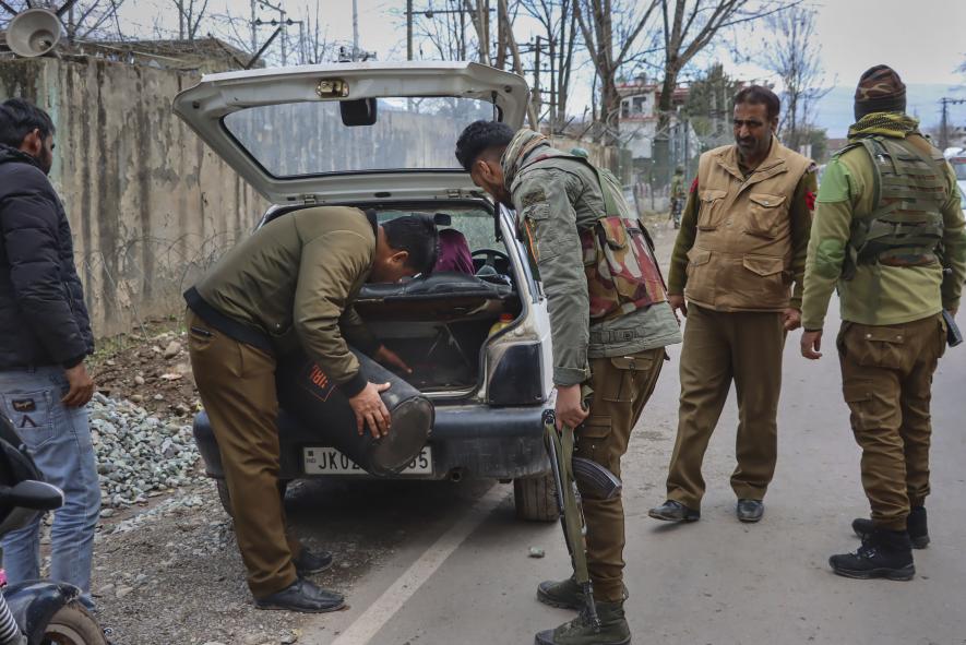 Security personnel check trunk of a car as security has been beefed up ahead of Union Home Minister Amit Shah's visit to Rajouri, in Poonch district, Thursday, Jan. 12, 2023.