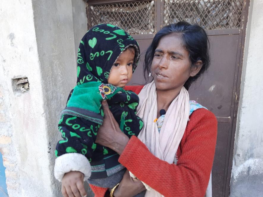 Nisha's mother with her youngest daughter who never leaves her sight. Nisha has been managing with compensation without any earning member of the family
