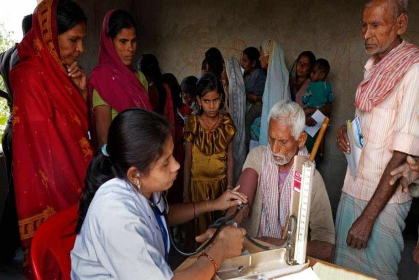 Free health check up being done at a village under National Rural Health Mission (2013) programme.