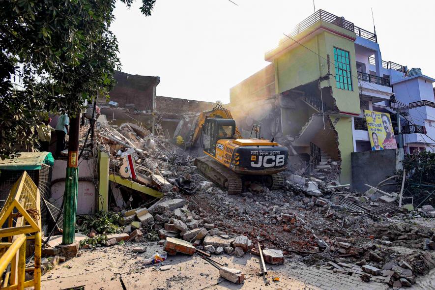 A Prayagraj Development Authority bulldozer demolishes Arms shopkeeper Safdar Ali's properties in the Chakiya area, in Prayagraj, Thursday, March 2, 2023. Ali is said to be a close aid of Atiq Ahmad.