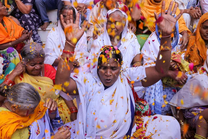 Widows participate in Holi celebrations at the ancient Gopinath Temple during an event organized by Sulabh International, in Vrindavan, Monday, March 6, 2023. (PTI Photo)