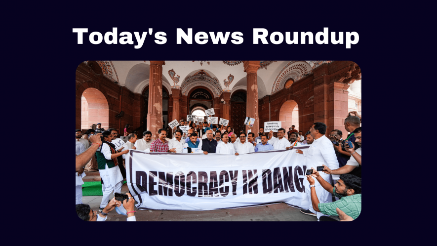 Congress President Mallikarjun Kharge and along with MPs of other like-minded opposition parties holds a "Democracy in Danger" banner before a protest march towards Rashtrapati Bhawan, at Parliament House complex in New Delhi, Friday, March 24, 2023. Opposition parties are protesting against conviction of Rahul Gandhi in a criminal defamation case and demanding JPC probe into Adani-Hindenburg issue.