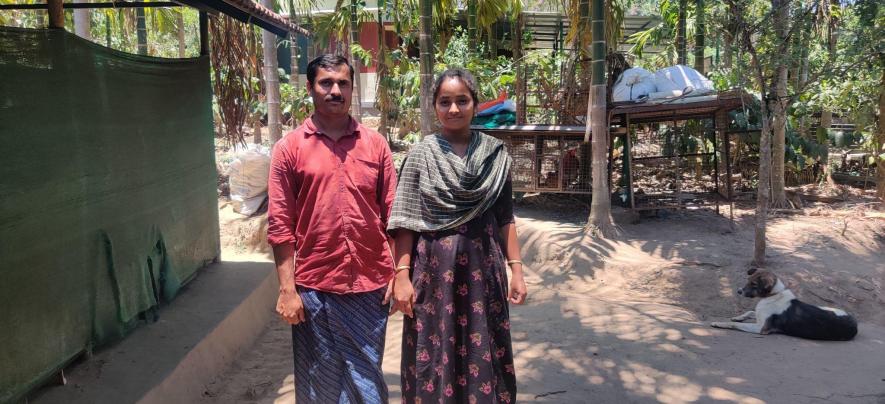 Ambika (R) and her husband Sivadass (L) outside their home in Muduguli.