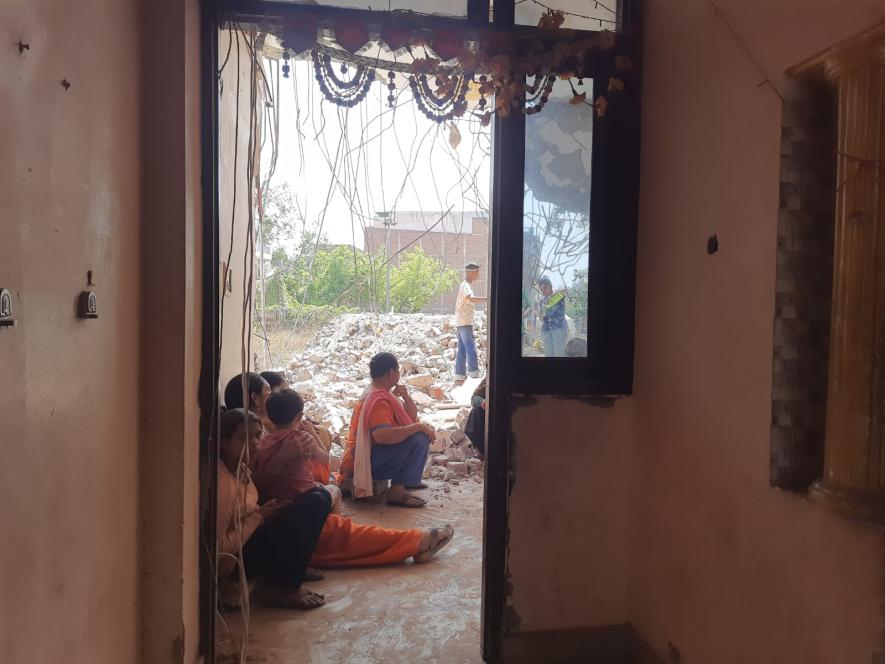 Jaswant Kaur along with her other relatives sitting in the broken house