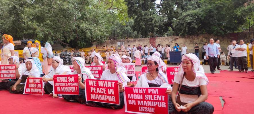 The members of the Joint Coordinating Committee for Peace of Imphal-based Khwairamband Ima Keithel protest at New Delhi’s Jantar Mantar on Monday.