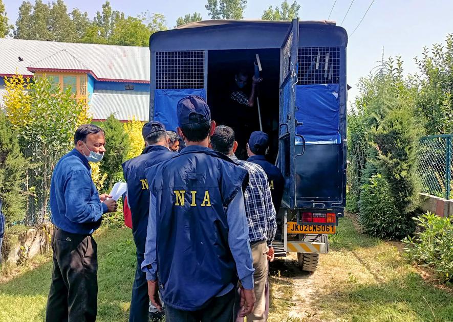 National Investigation Agency (NIA) sleuths during the installation of 'notice' mentioning the attachment of properties of businessman Zahoor Ahmad Shah Watali in connection with a terror funding case, in Kupwara, Monday, June 12, 2023. 