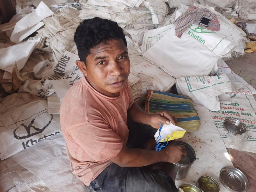 A worker inside the factory. He uses just one mask because he has trouble breathing and has to take the mask off at regular intervals in any case.