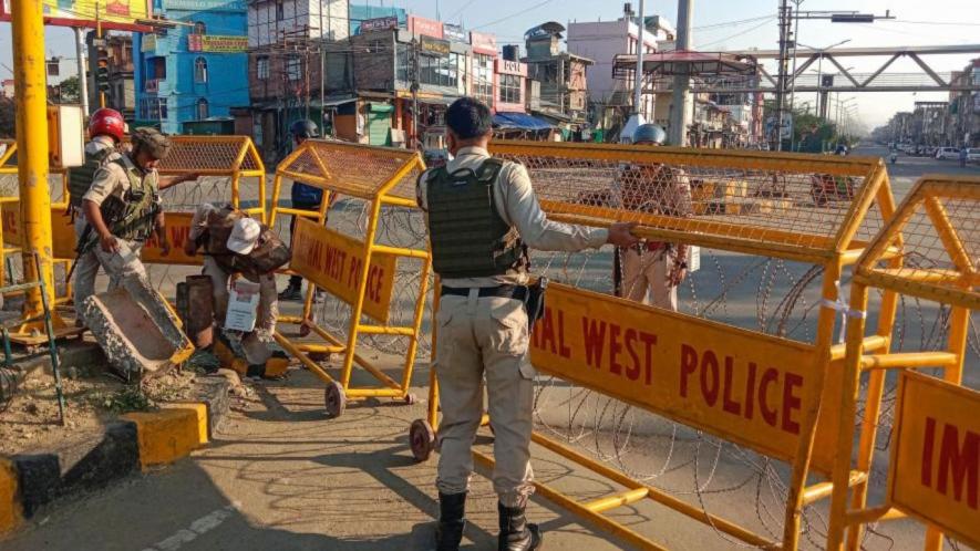 Police personnel stand guard in a violence-hit area of Imphal town, Manipur, Sunday, May 28, 2023.