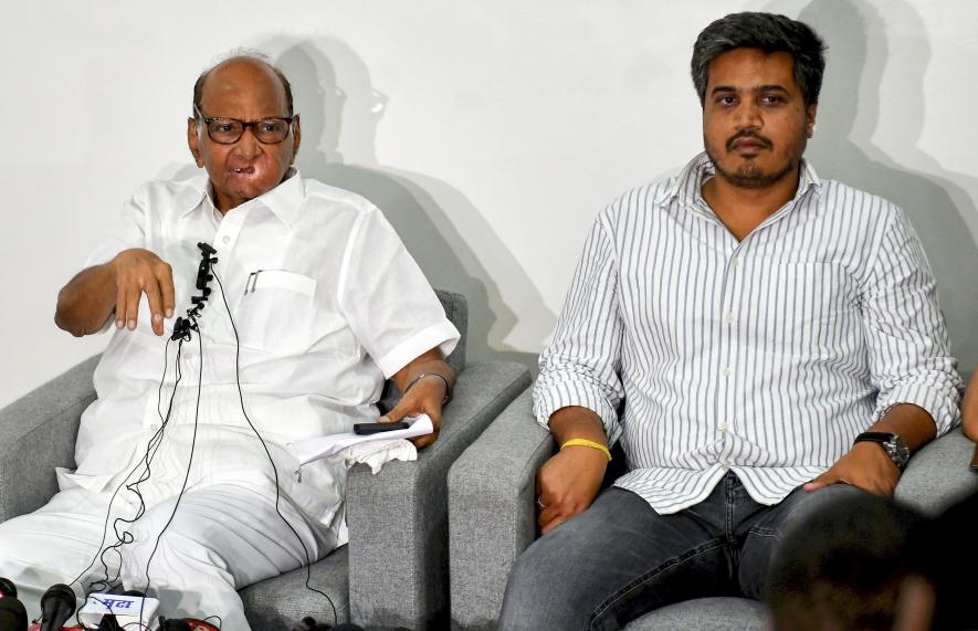 Nationalist Congress Party (NCP) President Sharad Pawar with party MLA Rohit Pawar speaks during a press conference at his residence, in Pune, Sunday, July 2, 2023.