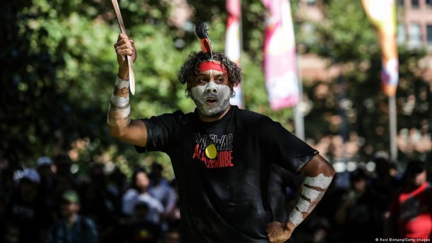 An Aboriginal Australian performs a traditional dance during Invasion Day protest at Belmore Park on January 26, 2023 in Sydney