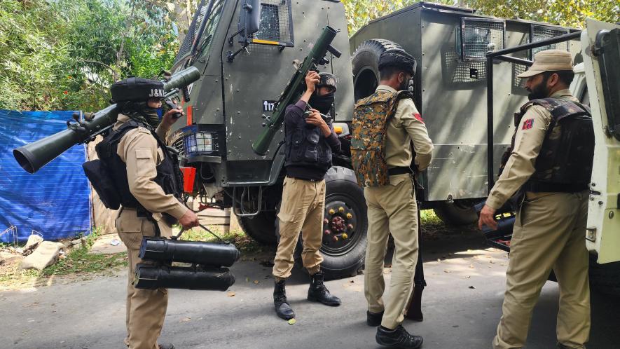 Army and police seen holding a rocket launcher at the encounter site.